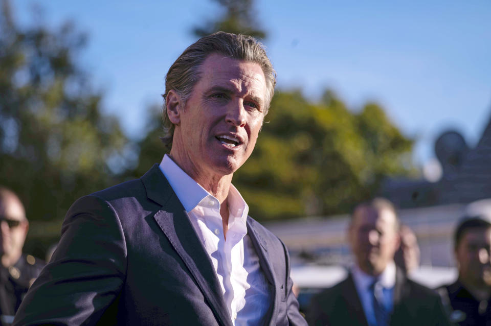 California Gov. Gavin Newsom speaks Tuesday, Jan. 24, 2023, at the I.D.E.S. Portuguese Hall in Half Moon Bay, Calif., with victims' families, local leaders and community members that were impacted by the devastating shootings the day before. (AP Photo/ Aaron Kehoe)