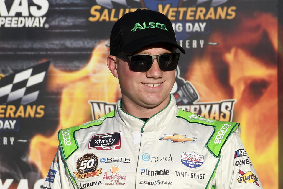 Tyler Reddick stands in Victory Lane after earning the pole for the NASCAR Xfinity Series auto race at Texas Motor Speedway in Fort Worth, Texas, Saturday, Nov. 2, 2019. (AP Photo/Randy Holt)