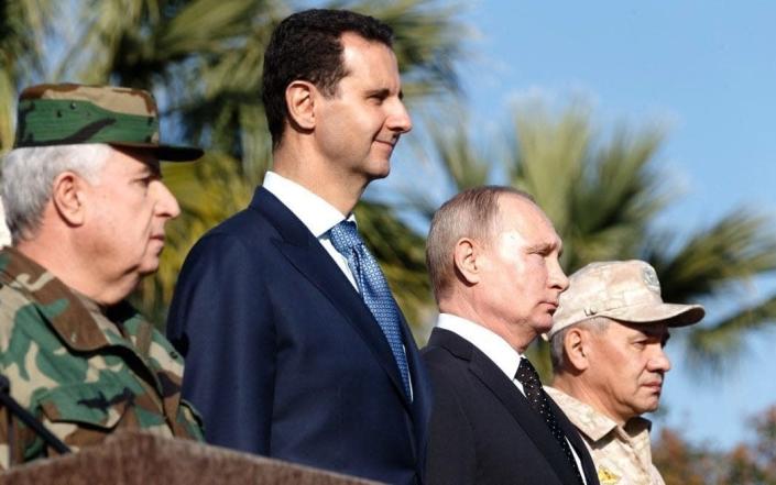 Vladimir Putin (2 L) with Bashar al-Assad (2 R) at Hmeymim base in Syria - Anadolu