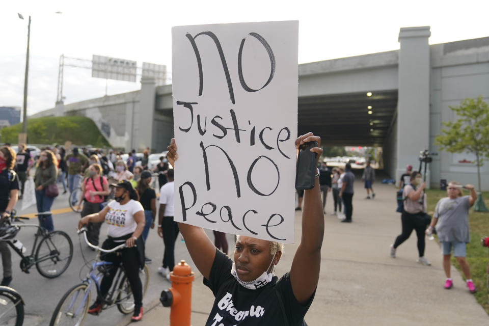 Victoria Gunther marches with Black Lives Matter protesters on Friday in Louisville, Ky. (Darron Cummings/AP)