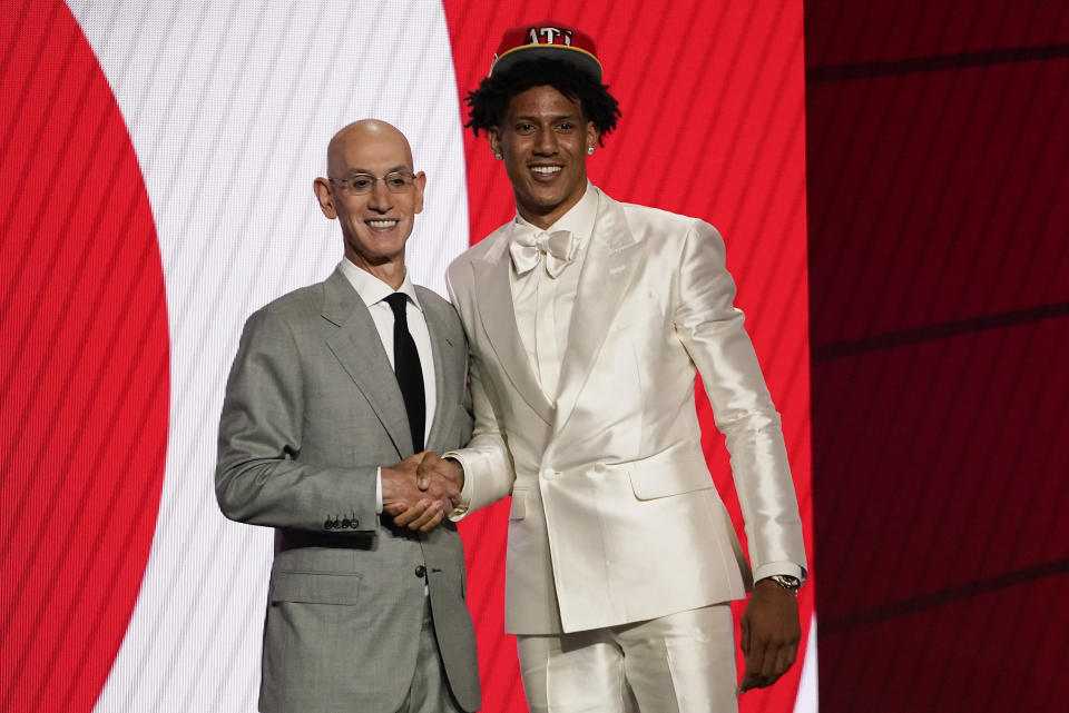 Jalen Johnson, right, poses for a photo with NBA Commissioner Adam Silver after being selected 20th overall by the Atlanta Hawks during the NBA basketball draft, Thursday, July 29, 2021, in New York. (AP Photo/Corey Sipkin)