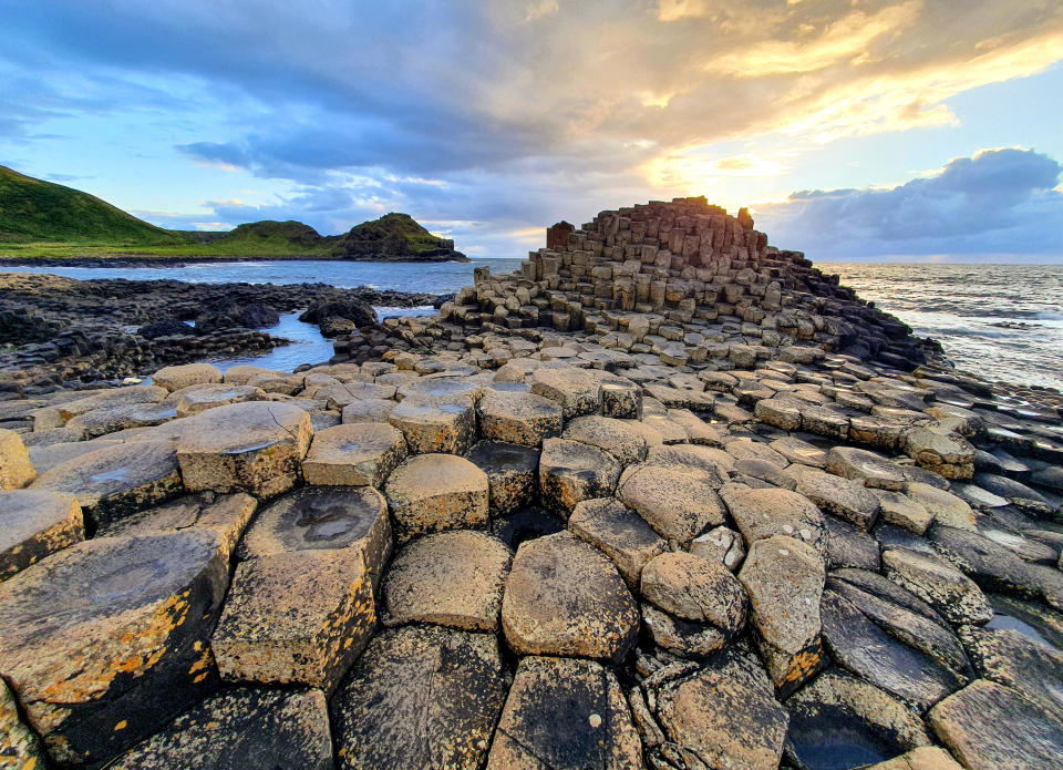 The Giant's Causeway with links on the water is a popular tourist attraction in Northern Ireland
