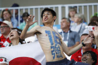 <p>A supporter of team Japan has the number sixteen, also in Japanese characters, painted on his body </p>