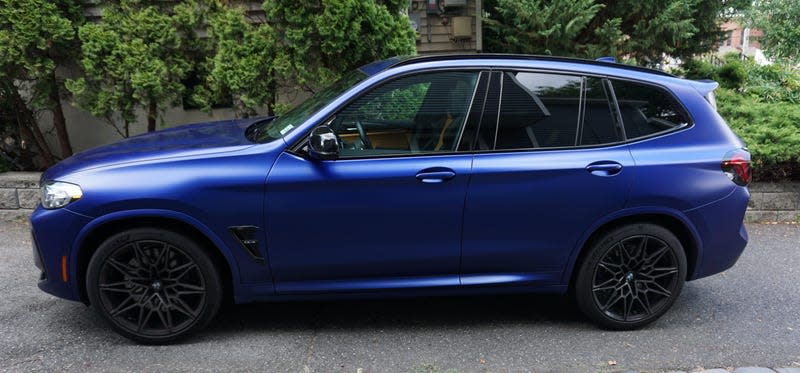 A photo of a blue 2022 BMW X3 M Competition.