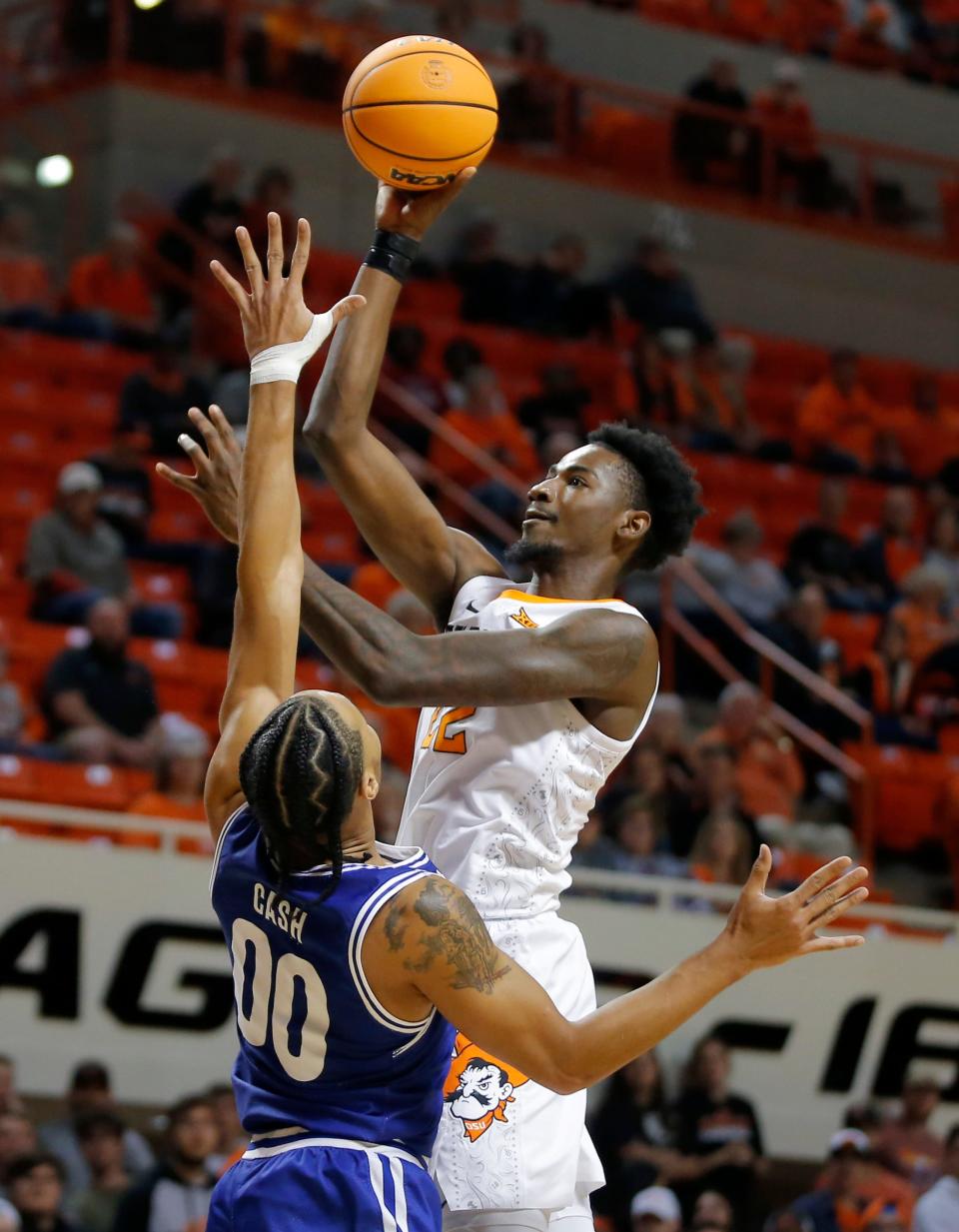 Oklahoma State forward Kalib Boone (22) puts up a shot over Texas-Arlington guard Aaron Cash (00) during a men's college basketball game between the Oklahoma State Cowboys (OSU) and UT Arlington at Gallagher-Iba Arena in Stillwater, Okla., Monday, Nov. 7, 2022.