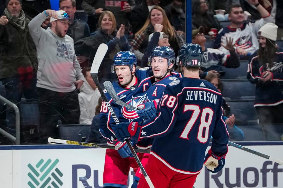 Nov 1, 2023; Columbus, Ohio, USA; Columbus Blue Jackets defenseman Damon Severson (78) and defenseman Zach Werenski (8) celebrate a goal by center Boone Jenner (38) during the third period of the NHL hockey game against the Tampa Bay Lightning at Nationwide Arena. The Blue Jackets won 4-2.