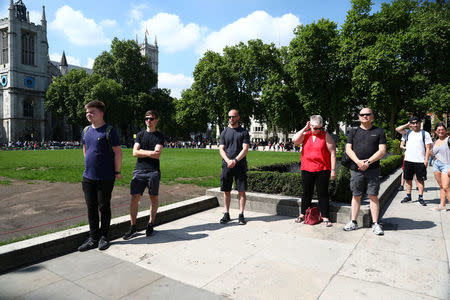 Members of the public observe a minute's silence following the recent Manchester Arena bombing, in Parliament Square in London, Britain, May 25, 2017. REUTERS/Neil Hall