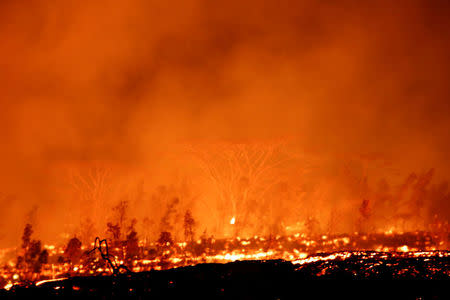 Lava flows through forest on the outskirts of Pahoa during ongoing eruptions of the Kilauea Volcano in Hawaii, U.S., May 18, 2018. REUTERS/Terray Sylvester