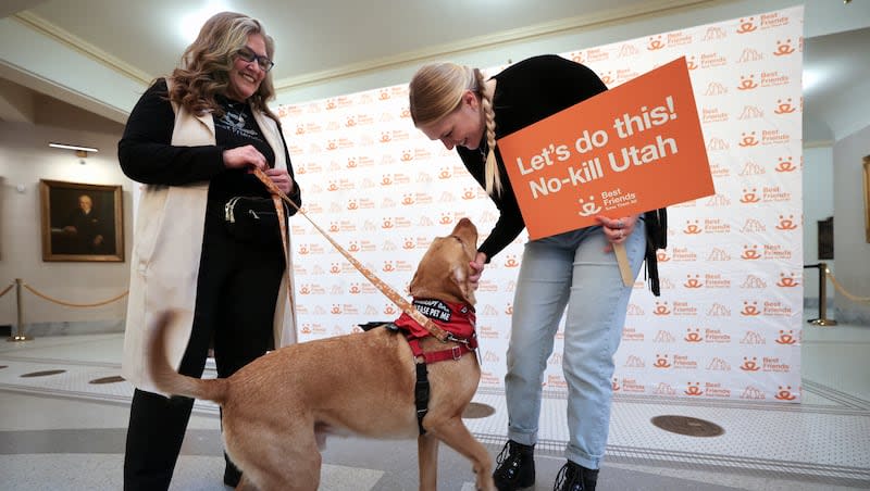 Beth Wolfer, Best Friends Animal Society planned giving officer, and her daughter Rose Wolfer, Best Friends Animal Society Salt Lake City foster coordinator, interact with Beth’s dog Edgar at an event celebrating Gov. Spencer Cox’s declaration of 2024 as No-Kill Shelter Year in Utah at the Capitol in Salt Lake City on Tuesday, Feb. 27, 2024. Edgar was adopted from CAWS and now volunteers with Intermountain Therapy Animals.