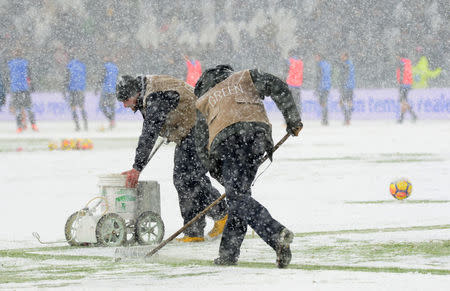 Soccer Football - Serie A - Juventus v Atalanta - Allianz Stadium, Turin, Italy - February 25, 2018 Groundstaff in the snow before the match was postponed REUTERS/Massimo Pinca