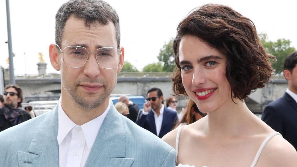 Jack Antonoff in a blue suit and Margaret Qualley in a white strappy dress