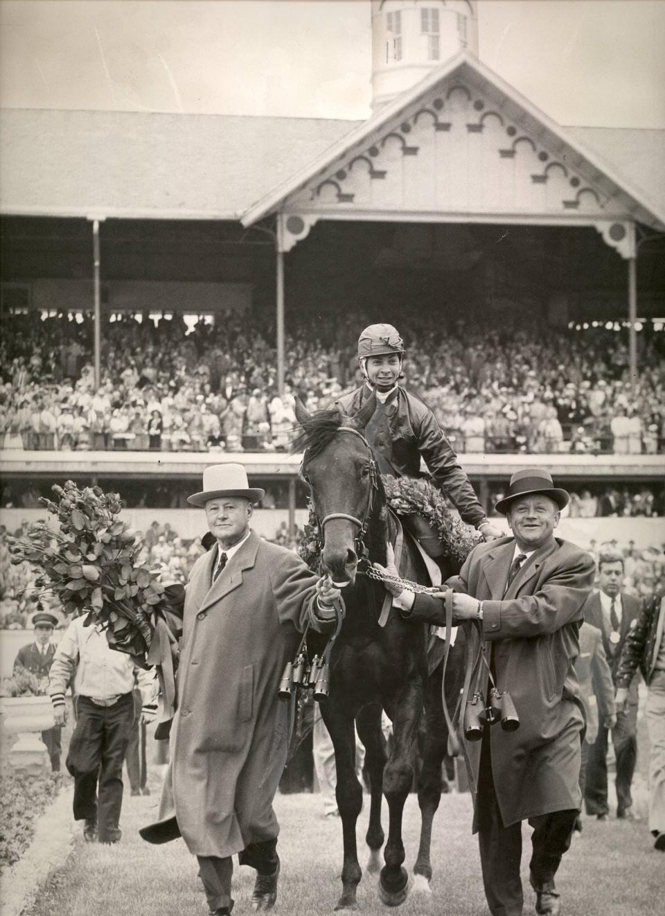 Jockey Bill Hartack holds the roses he and Iron Liege won by beating out Gallant Man in the Kentucky Derby on May 4, 1957.