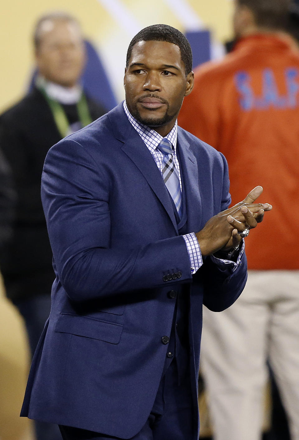 Former NFL football player Michael Strahan watches during the first half of the NFL Super Bowl XLVIII football game between the Seattle Seahawks and the Denver Broncos Sunday, Feb. 2, 2014, in East Rutherford, N.J. (AP Photo/Kathy Willens)