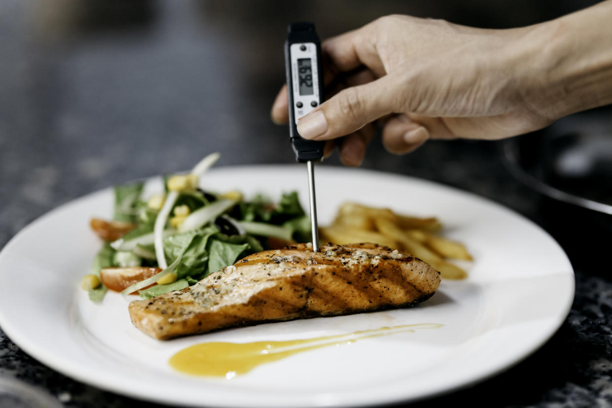 Chef uses a thermometer to measure the temperature of the pan seared salmon fillet, Amazon meat thermometer