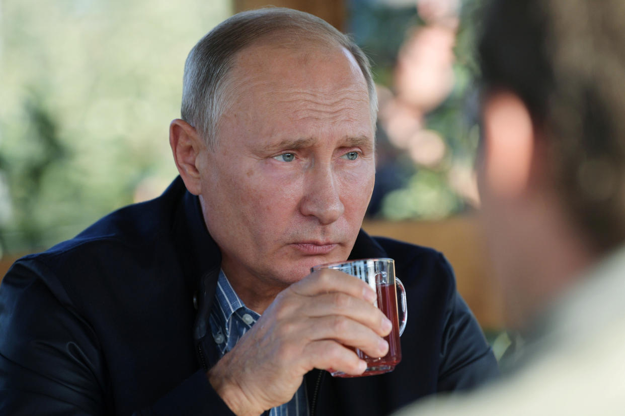 Russian President Vladimir Putin drinks apple juice during his visit to the Rassvet agricultural company in Stavropol region, Russia October 9, 2018. Sputnik/Alexei Druzhinin/Kremlin via REUTERS ATTENTION EDITORS - THIS IMAGE WAS PROVIDED BY A THIRD PARTY.