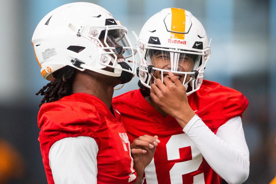 Tennessee quarterbacks Joe Milton III (7) and Nico Iamaleava (12) share a laugh together during spring football practice on Monday, March 20, 2023.