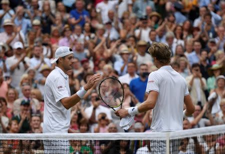 Tennis - Wimbledon - All England Lawn Tennis and Croquet Club, London, Britain - July 13, 2018 South Africa's Kevin Anderson shakes hands with John Isner of the U.S. after winning their semi final match REUTERS/Tony O'Brien