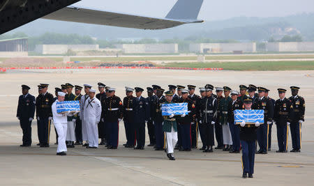 U.N. honor guards carry small boxes containing remains believed to be from American servicemen killed during the 1950-53 Korean War after they arrived from North Korea, at Osan Air Base in Pyeongtaek, South Korea, Friday, July 27, 2018. Ahn Young-joon/Pool via Reuters