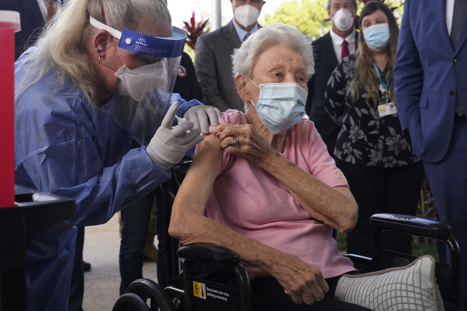 Nurse Christine Philips, left, administers the Pfizer vaccine to Vera Leip, 88, a resident of John Knox Village, Wednesday, Dec. 16, 2020, in Pompano Beach, Fla. Nursing home residents and health care workers in Florida began receiving the Pfizer vaccine this week. (AP Photo/Marta Lavandier)