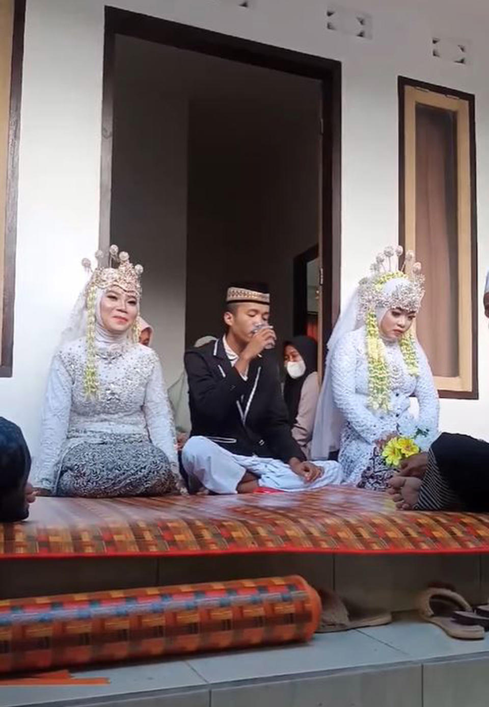 Nur Khusnul Kotimah, 20, Yuanita Ruri, 21, and their new husband Korik Akbar, 20. Source: Newsflash/Australscope