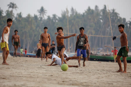 Residents play football on Ngapali beach in Thandwe, Rakhine State, Myanmar February 19, 2019. REUTERS/Ann Wang