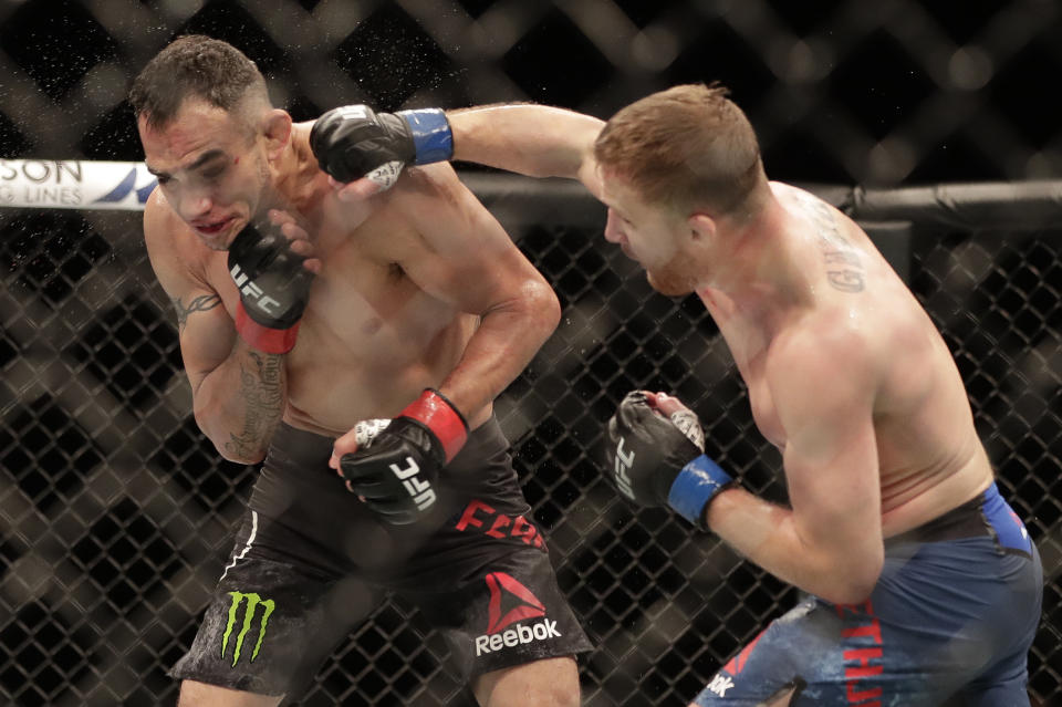 Justin Gaethje, right, punches Tony Ferguson during a UFC 249 mixed martial arts bout, Saturday, May 9, 2020, in Jacksonville, Fla. (AP Photo/John Raoux)