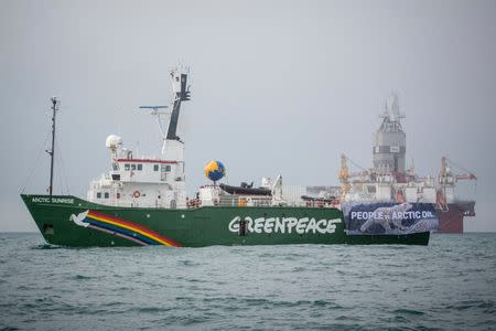 Greenpeace's Arctic Sunrise vessel displays a banner reading "People vs. Arctic Oil" as it sails during a protest next to Statoil's Songa Enabler rig in the Barents sea, Norway, July 21, 2017. Will Rose/Greenpeace/Handout via Reuters