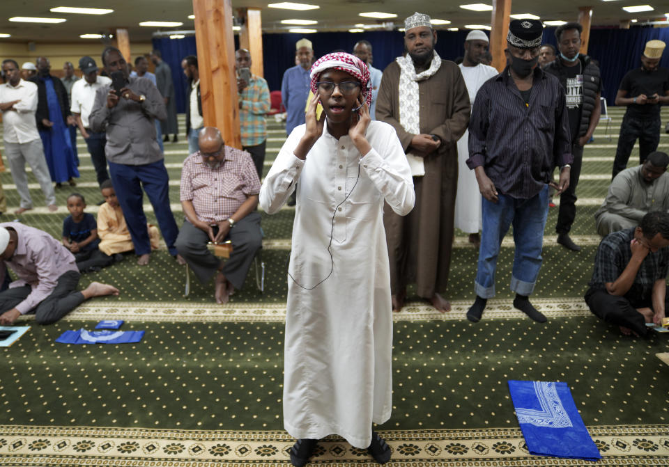 Dalha Abdi, 15, calls the adhan, or Islamic call to prayer, on Thursday, May 12, 2022, at the Abubakar As-Saddique Islamic Center in south Minneapolis. The call exhorts men to go to the closest mosque five times a day for prayer, which is one of the Five Pillars of Islam. (AP Photo/Jessie Wardarski)