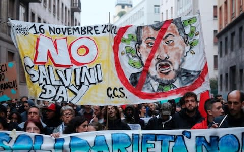 Anti Salvini protestors in Milan march in support of Domenico Lucano, a mayor in southern Italy jailed for allegedly helping illegal immigration - Credit:  Matteo Bazzi/ANSA