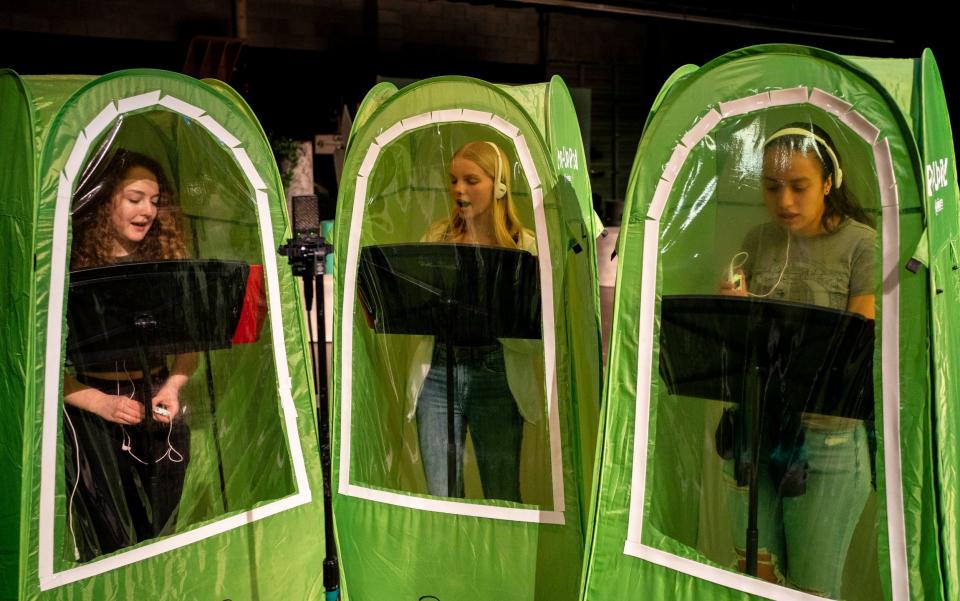 Emma Banker, Jessi McIrvin, and Valerie Sanchez record vocals in pop-up tents during choir class at Wenatchee High School - David Ryder/ Getty Images North America