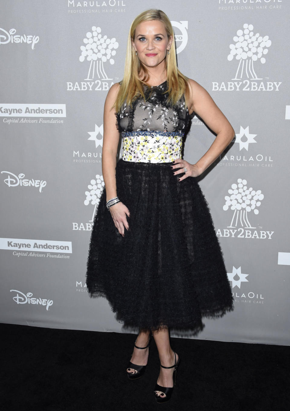 Reese Witherspoon wears a black and floral tulle cocktail dress at the 2015 Baby2Baby Gala at 3LABS on Nov. 14, 2015 in Culver City, California.
