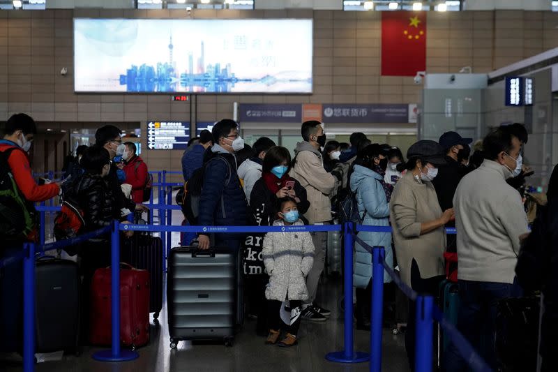 Passengers wearing masks are seen at the Pudong International Airport in Shanghai