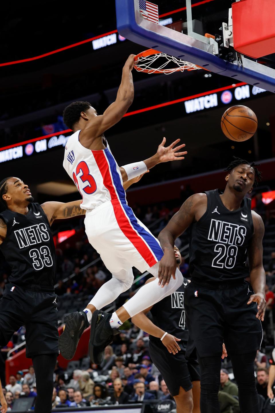 Detroit Pistons guard Jaden Ivey (23) dunks on Brooklyn Nets forward Dorian Finney-Smith (28) in the first half at Little Caesars Arena in Detroit on Thursday, March 7, 2024.