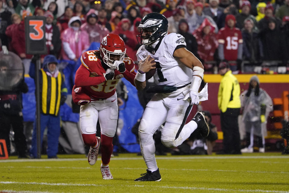 Philadelphia Eagles quarterback Jalen Hurts (1) scores on a touchdown run past Kansas City Chiefs cornerback L'Jarius Sneed (38) during the second half of an NFL football game, Monday, Nov. 20, 2023, in Kansas City, Mo. (AP Photo/Ed Zurga)