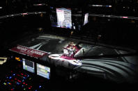 A banner is raised to honor former Colorado Avalanche general manager Pierre Lacroix, who died from complications of COVID-19 last December, before the Avalanche host the St. Louis Blues in an NHL hockey game Saturday, Oct. 16, 2021, in Denver. (AP Photo/David Zalubowski)