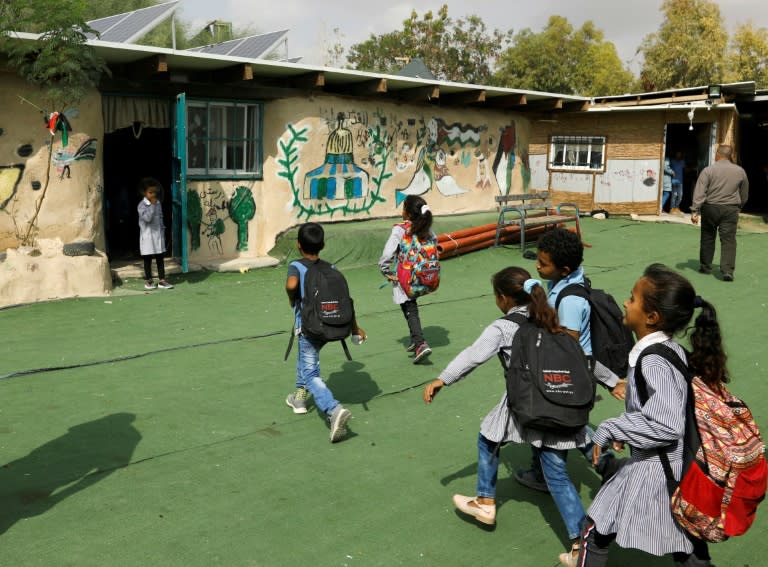 Palestinian Bedouin schoolchildren play in the yard of their school in the Bedouin village of Khan al-Ahmar, east of Jerusalem, in the occupied West Bank