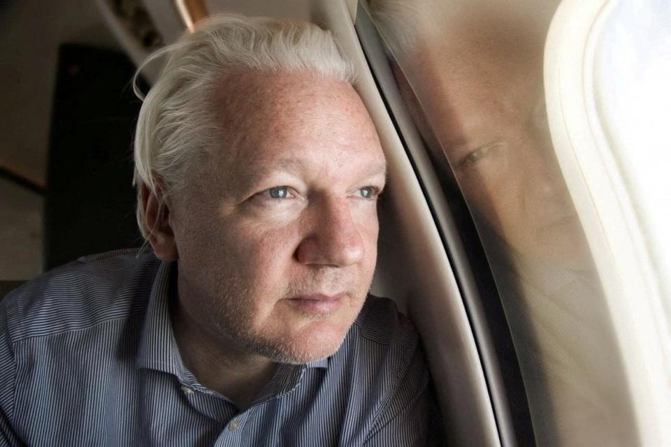 PHOTO: WikiLeaks founder Julian Assange looks out a plane window as he approaches Bangkok airport for layover, according to the post by Wikileaks on X, in this picture released to social media on June 25, 2024.  (Wikileaks/X via Reuters)