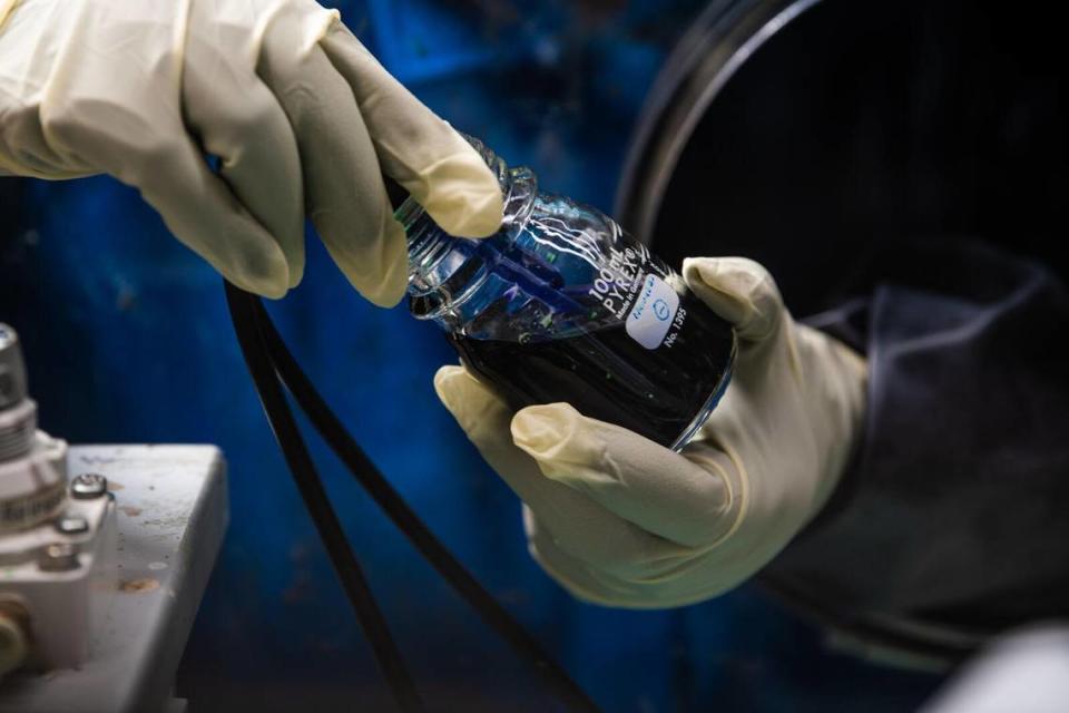 Researchers prepare an experimental flow battery electrolyte. In a 2023 study, scientists at PNNL used a dissolved simple sugar called β-cyclodextrin, a derivative of starch, to boost flow battery longevity and capacity. Photo by Andrea Starr | Pacific Northwest National Laboratory