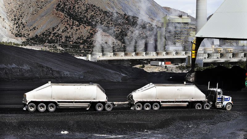 A truck dumps coal at the Huntington power plant in Huntington on Tuesday, March 24, 2015.