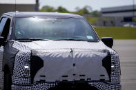 President Joe Biden drives a Ford F-150 Lightning truck at Ford Dearborn Development Center, Tuesday, May 18, 2021, in Dearborn, Mich. (AP Photo/Evan Vucci)