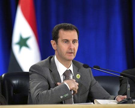 Syria's President Bashar al-Assad speaks during his meeting with the leadership al-Baath party of Damascus countryside,in Damascus March 8, 2014,in this handout released by Syria's national news agency SANA. REUTERS/SANA/Handout via Reuters