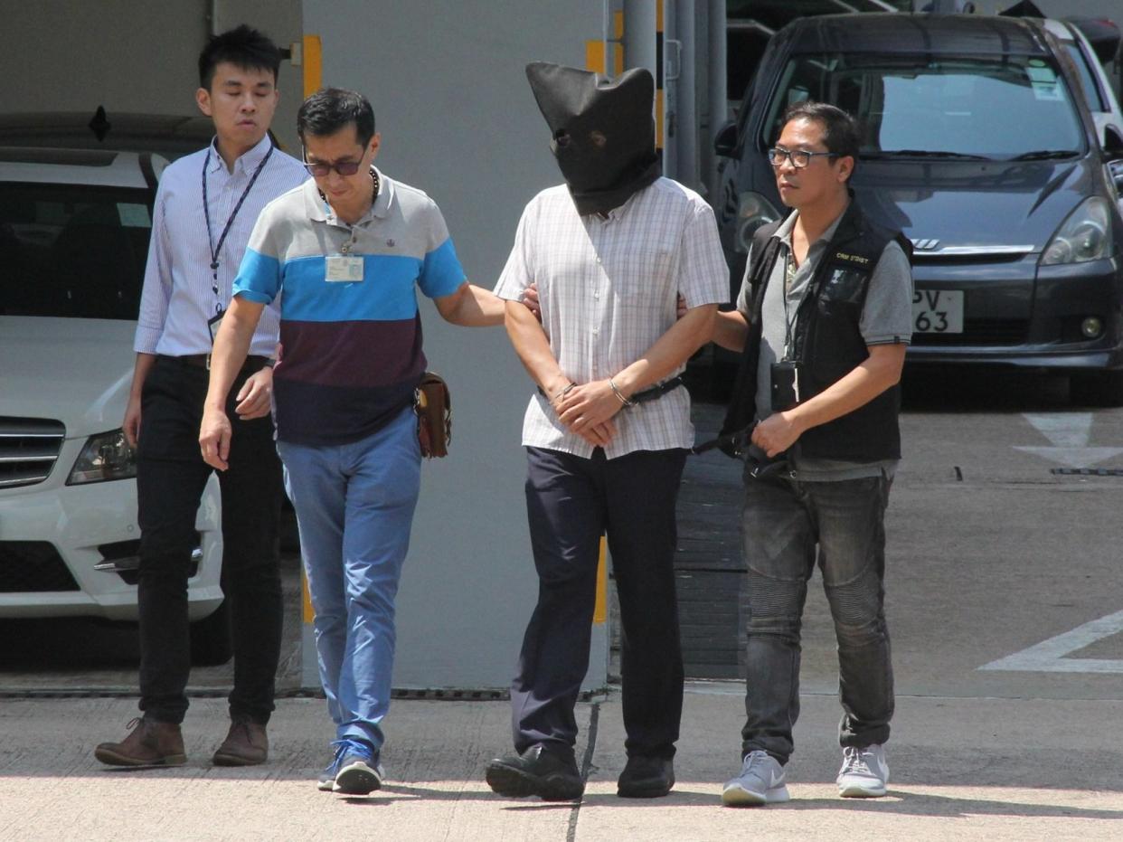 Khaw Kim Sun being escorted by Hong Kong police in 2017: AFP/Getty Images