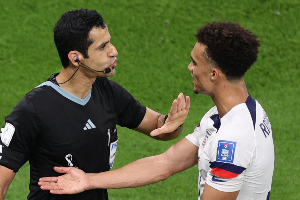 Qatari referee Abdulrahman Al Jassim (L) speaks with USA's defender #05 Antonee Robinson during the Qatar 2022 World Cup Group B football match between USA and Wales at the Ahmad Bin Ali Stadium in Al-Rayyan, west of Doha on November 21, 2022. (Photo by ADRIAN DENNIS / AFP) (Photo by ADRIAN DENNIS/AFP via Getty Images)