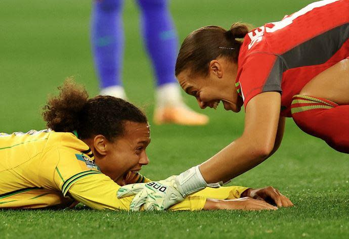 Jamaican national team goalie Rebecca Spencer, right, and midfielder Drew Spence celebrate after drawing against Brazil to advance to the knockout stages  of the 2023 FIFA Women's World Cup, in Melbourne, Australia, August 2, 2023. / Credit: REUTERS/Hannah Mckay