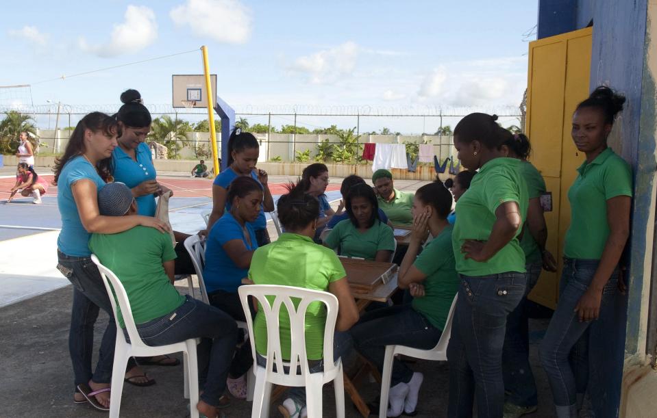 Prisoners play dominoes in the yard of the renovated wing of the Najayo Women's prison in San Cristobal