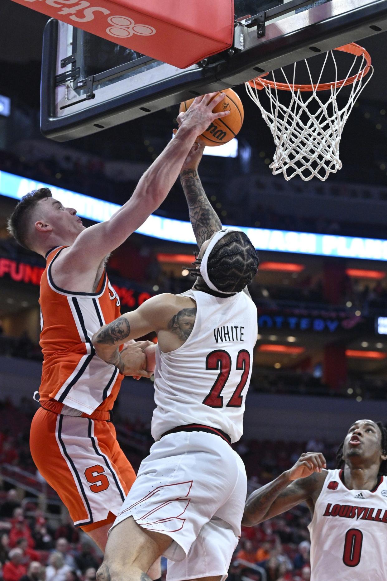 Mar 2, 2024; Louisville, Kentucky, USA; Syracuse Orange guard Justin Taylor (5) blocks the shot of Louisville Cardinals guard Tre White (22) during the second half at KFC Yum! Center. Syracuse defeated Louisville 82-76. Mandatory Credit: Jamie Rhodes-USA TODAY Sports