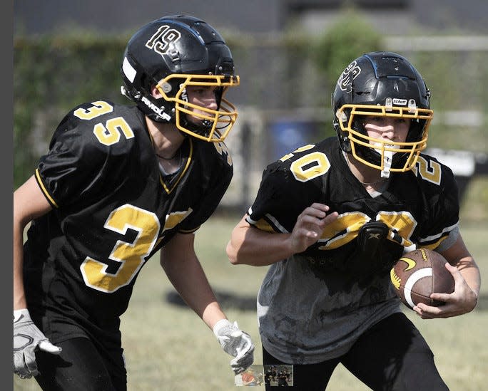 Copan High School's Shooter Brewington, right, advances the ball while Logan Guess seals off the inside during practice in August 2023.