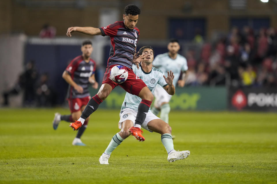 Toronto FC midfielder Brandon Servania, front, works for the ball next to Atlanta United midfielder Santiago Sosa during the first half of an MLS soccer match Saturday, April 15, 2023, in Toronto. (Andrew Lahodynskyj/The Canadian Press via AP)