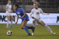 BYU's Laveni Vaka, left, moves the ball past Florida State's Beata Olsson (30) during the first half in the NCAA College Cup women's soccer final Monday, Dec. 6, 2021, in Santa Clara, Calif. (AP Photo/Tony Avelar)