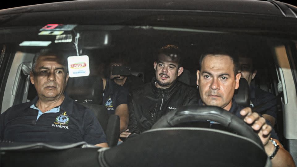 Joran van der Sloot (center) is transferred in a police car from the Ancon I jail in Lima, Peru, on June 8. - Ernesto Benavides/AFP/Getty Images